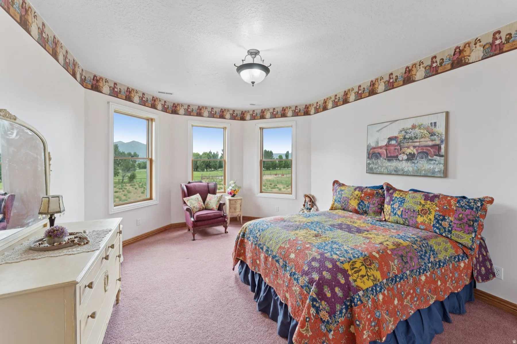 Bedroom featuring light colored carpet and a textured ceiling
