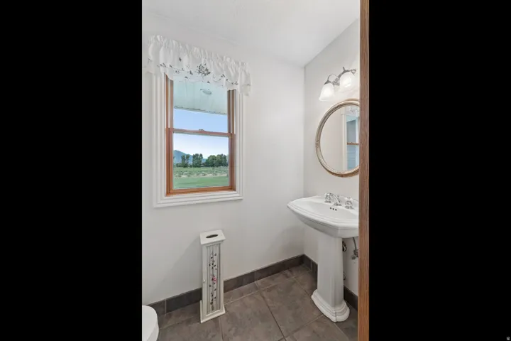 Bathroom with toilet and dark tile patterned flooring