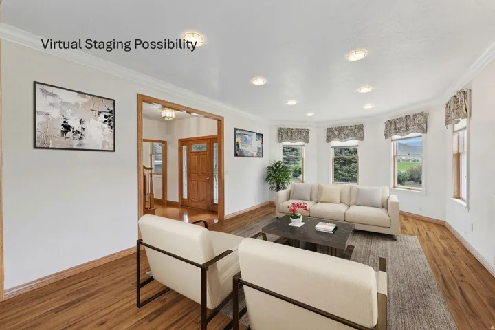 Living room featuring ornamental molding and wood finished floors