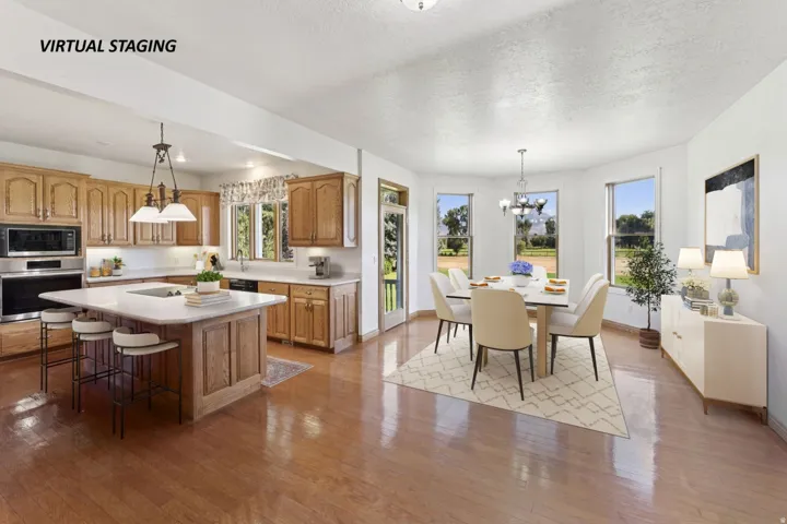 Kitchen with stainless steel appliances, light countertops, a textured ceiling, a kitchen island, and hanging lights