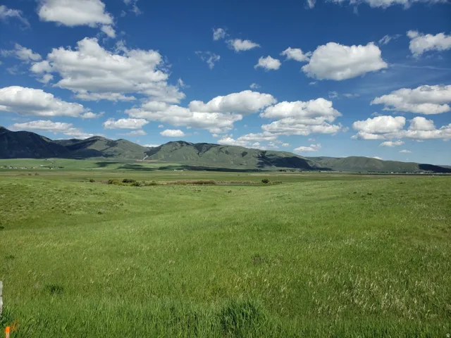 View of mountain background with rural landscape and agricultural land