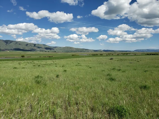 View of mountain backdrop featuring rural landscape and agricultural land
