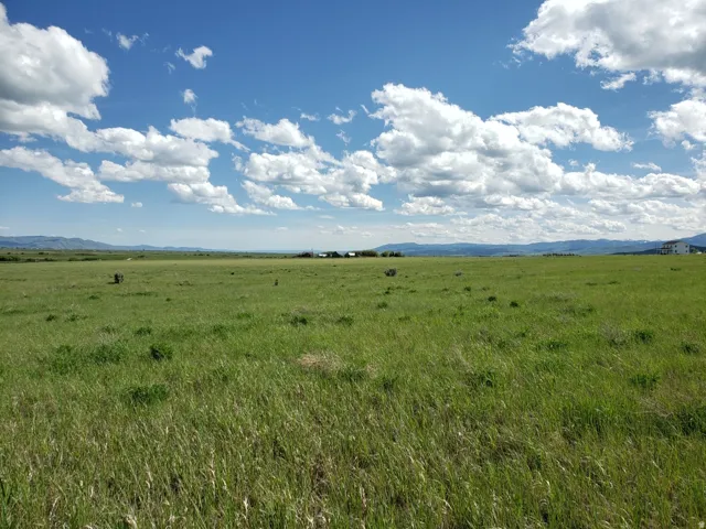 View of undeveloped land with a mountain backdrop and rural landscape