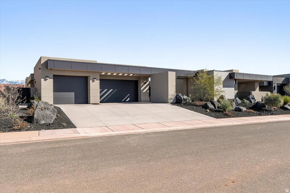 Modern home with stucco siding, driveway, and a garage