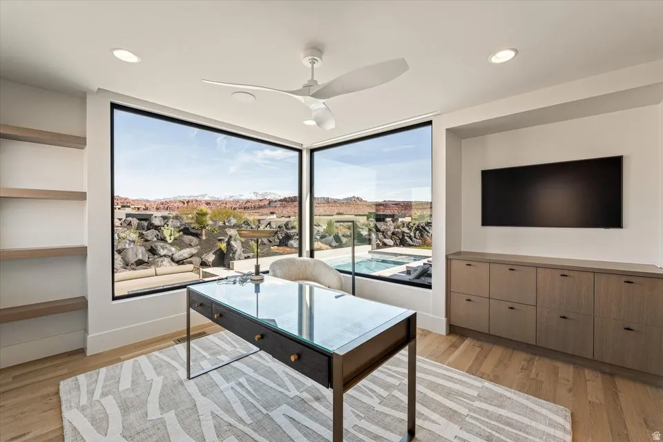 Home office with light wood-type flooring, a ceiling fan, and recessed lighting