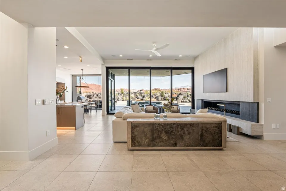 Living area featuring plenty of natural light, ceiling fan, and recessed lighting