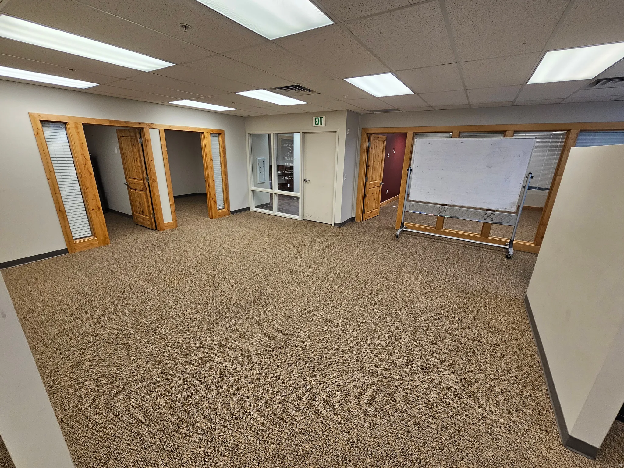 Basement with carpet and a paneled ceiling