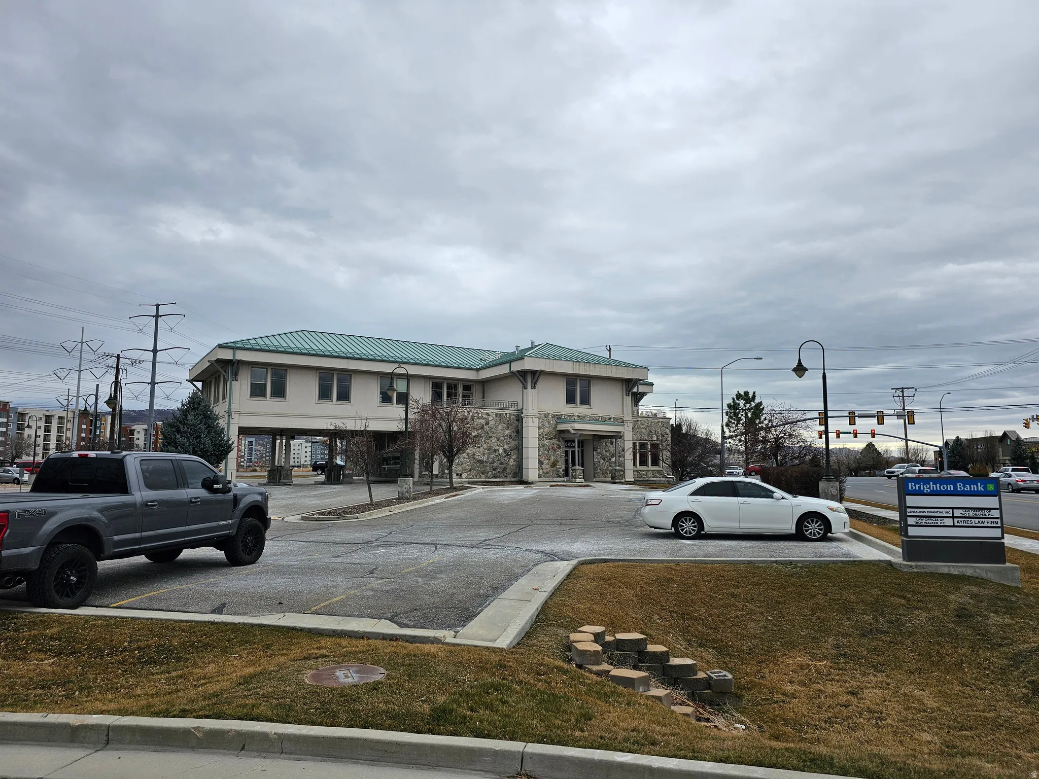 View of front facade with a metal roof and stone siding