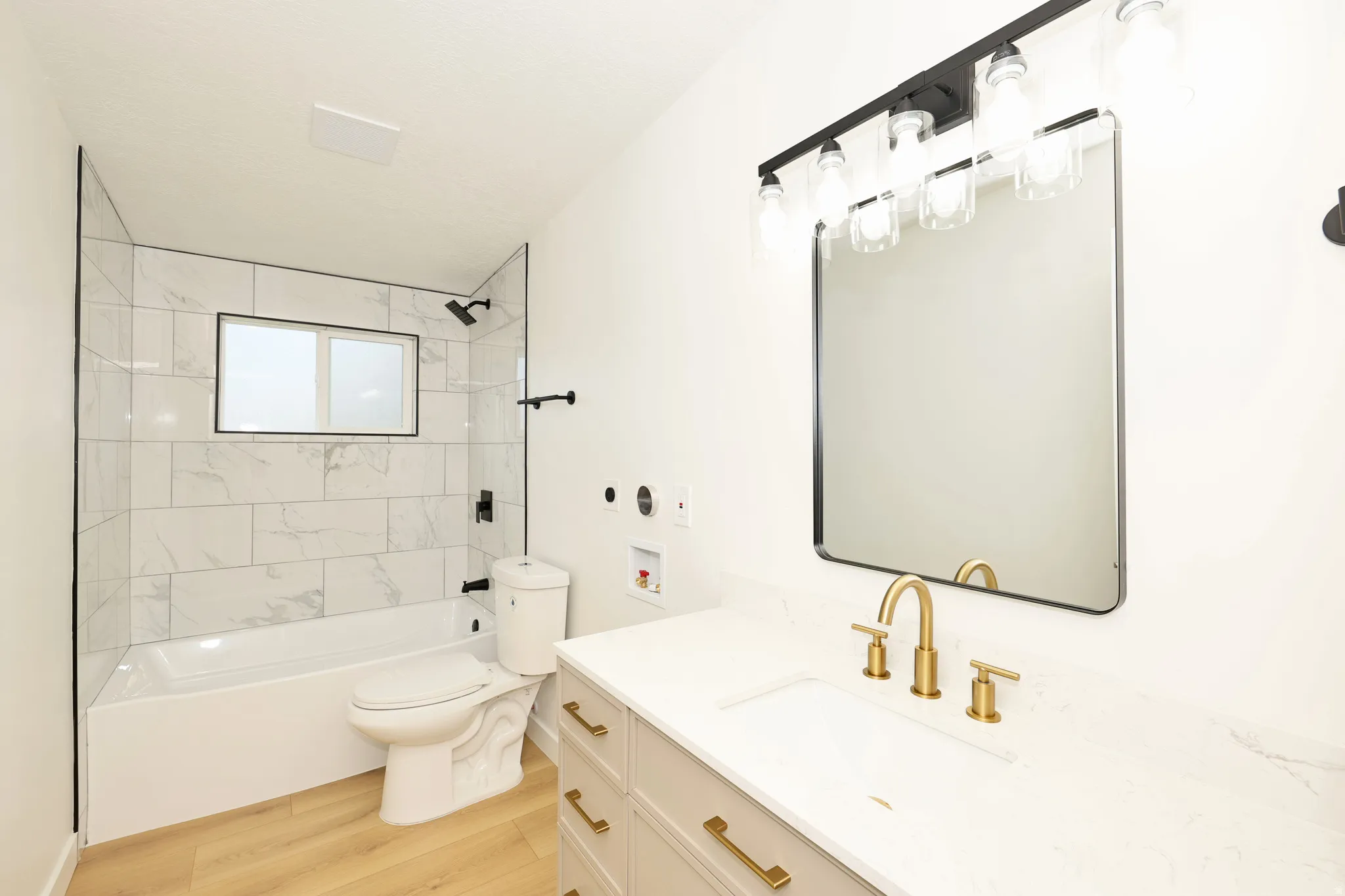 Full bath featuring vanity, shower / washtub combination, and light wood-type flooring