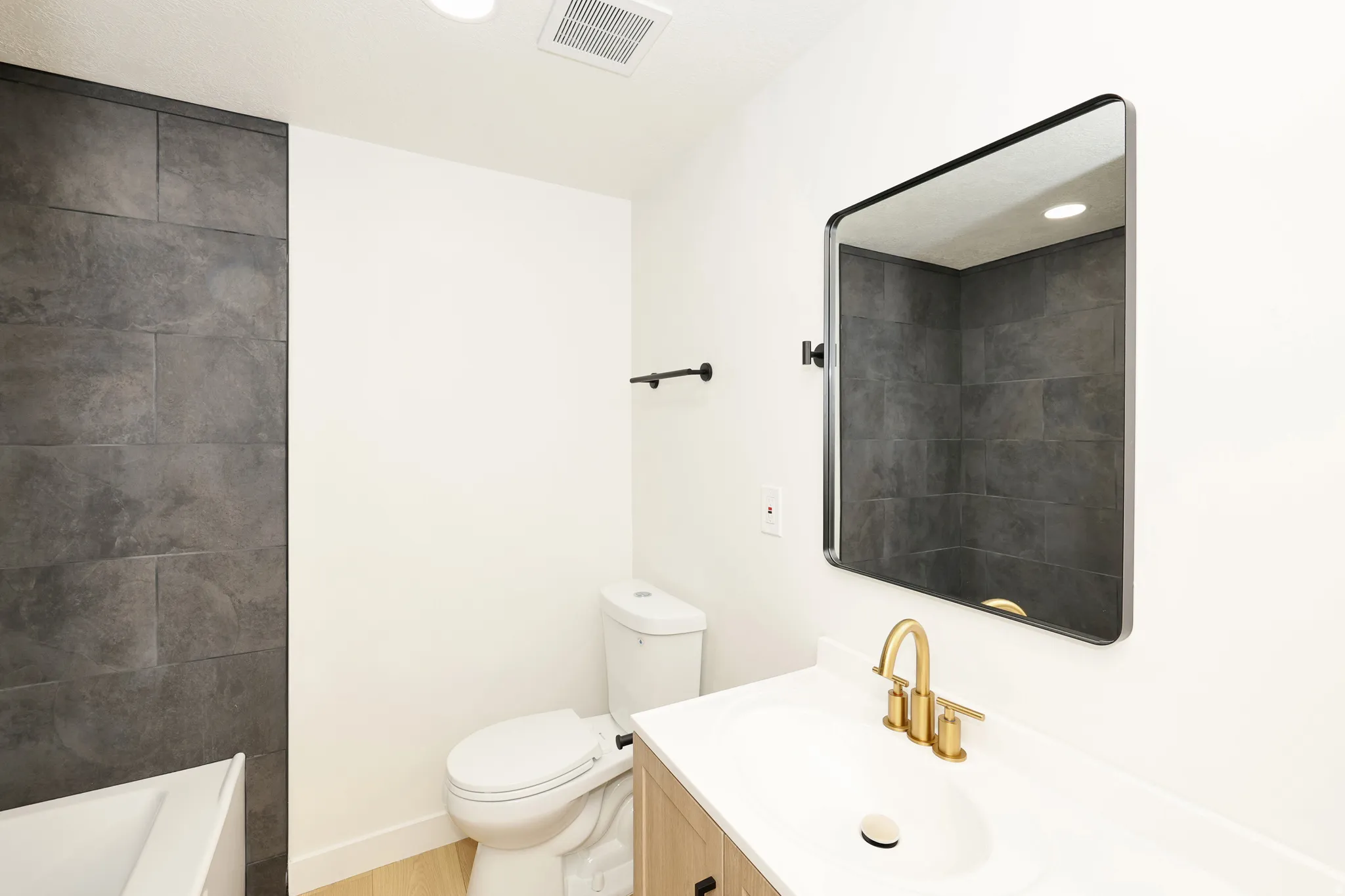 Full bath featuring vanity, recessed lighting, a bath, light wood finished floors, and a shower