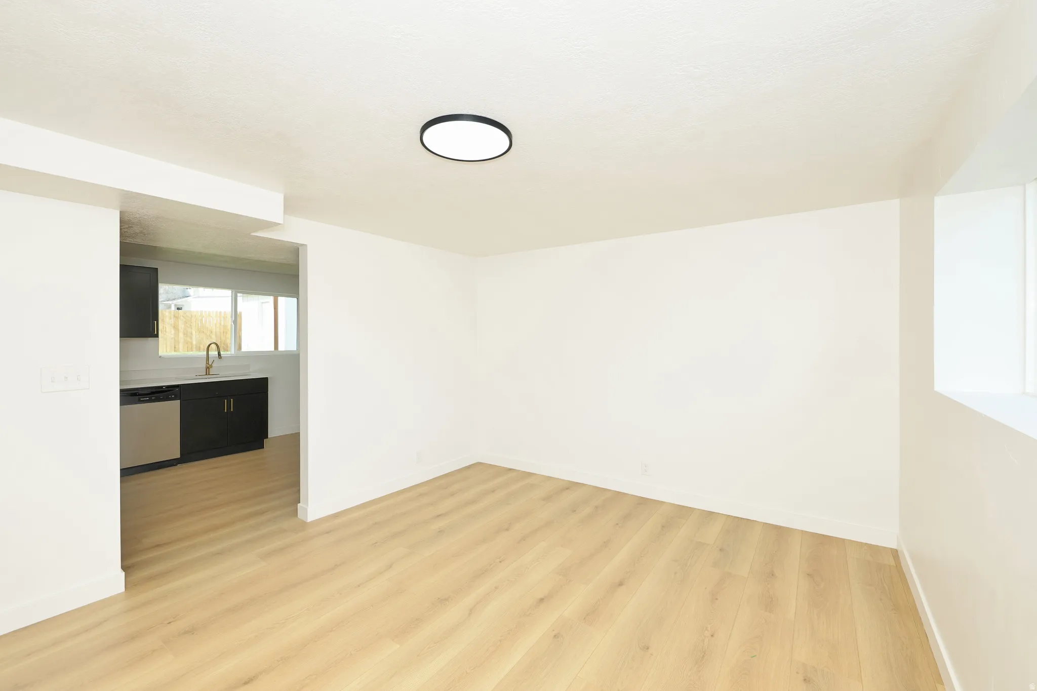 Empty room featuring light wood finished floors and baseboards