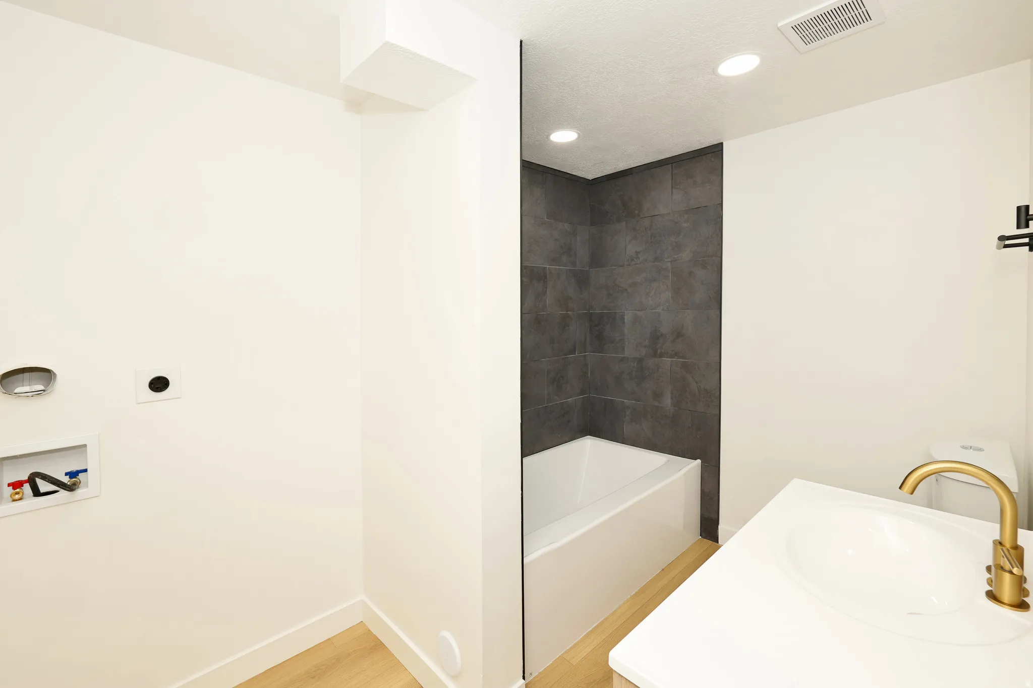 Full bathroom with vanity, light wood finished floors, and recessed lighting