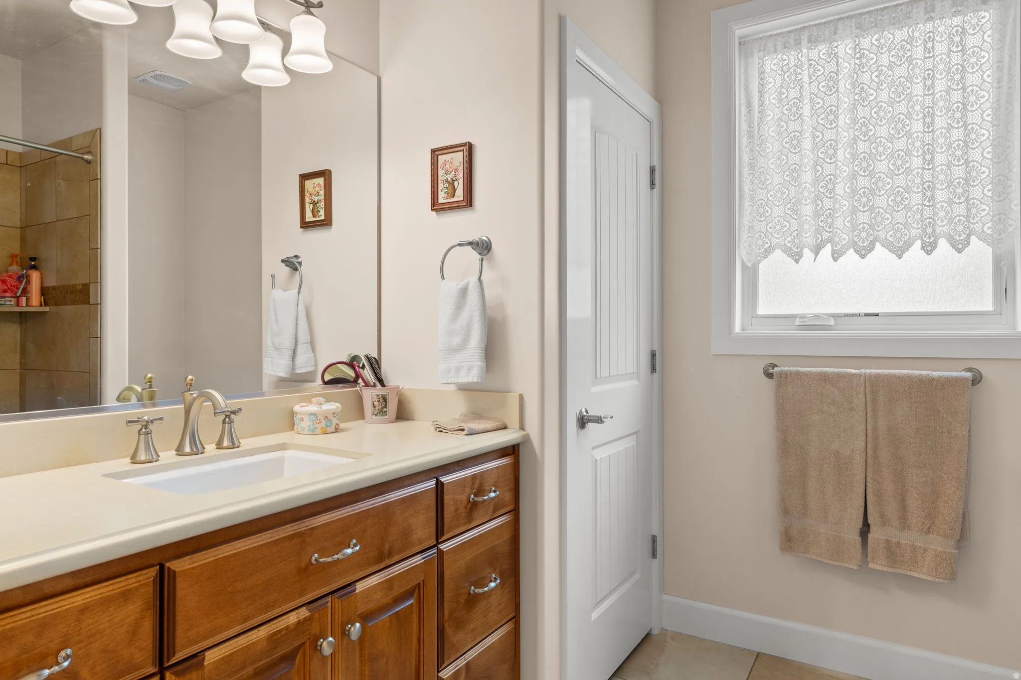Bathroom with vanity and light tile patterned flooring