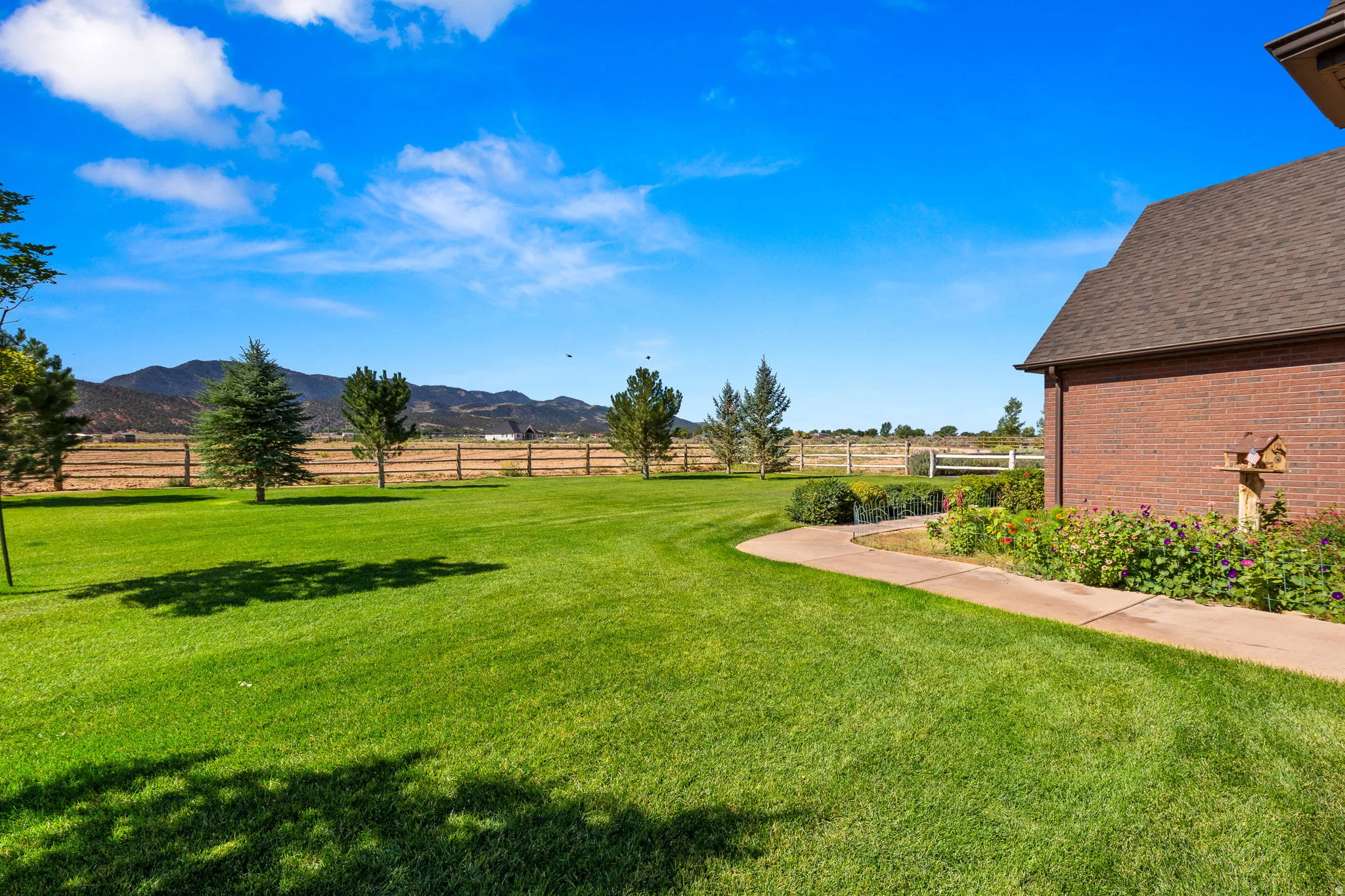 View of yard with a rural view and a mountain view