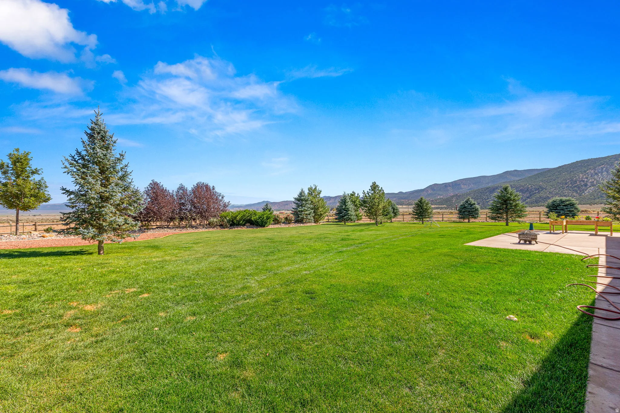 View of yard with a mountain view, a view of rural / pastoral area, and an outdoor fire pit