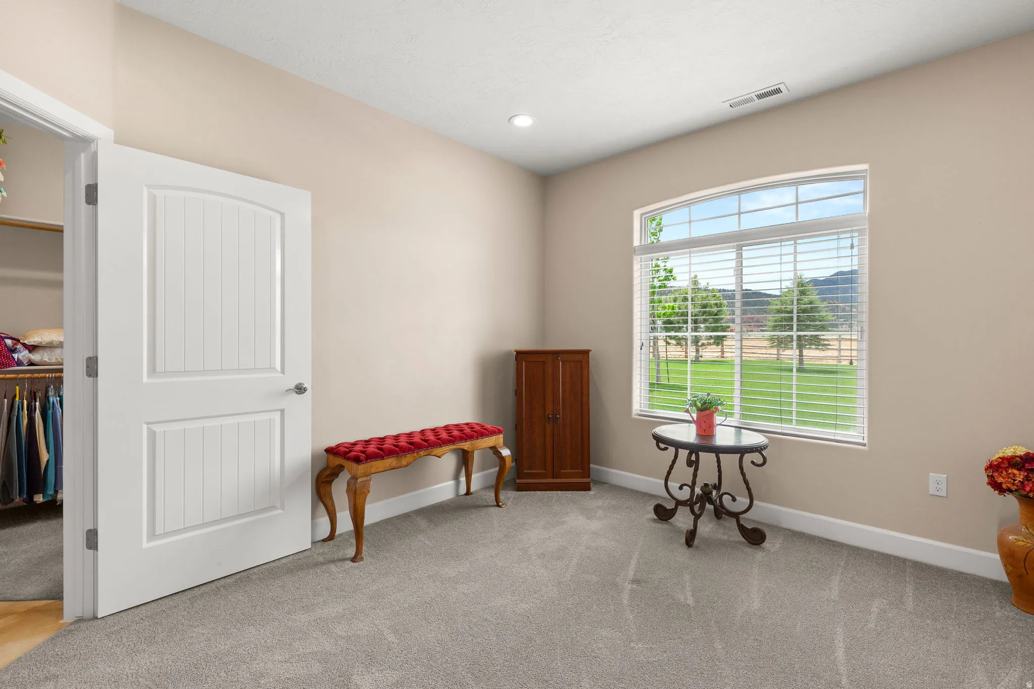 Sitting room with light carpet and recessed lighting