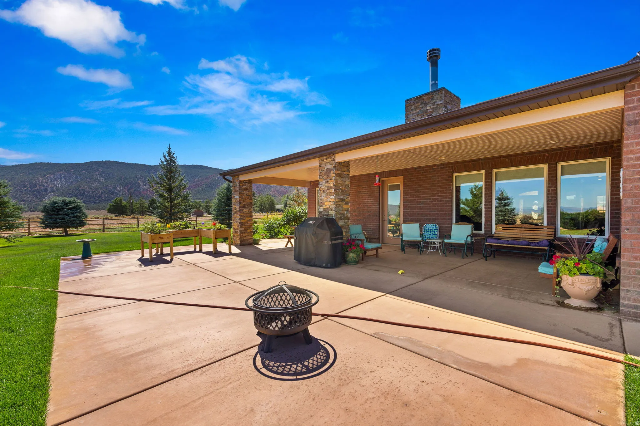 View of patio / terrace with a fire pit, a mountain view, and area for grilling