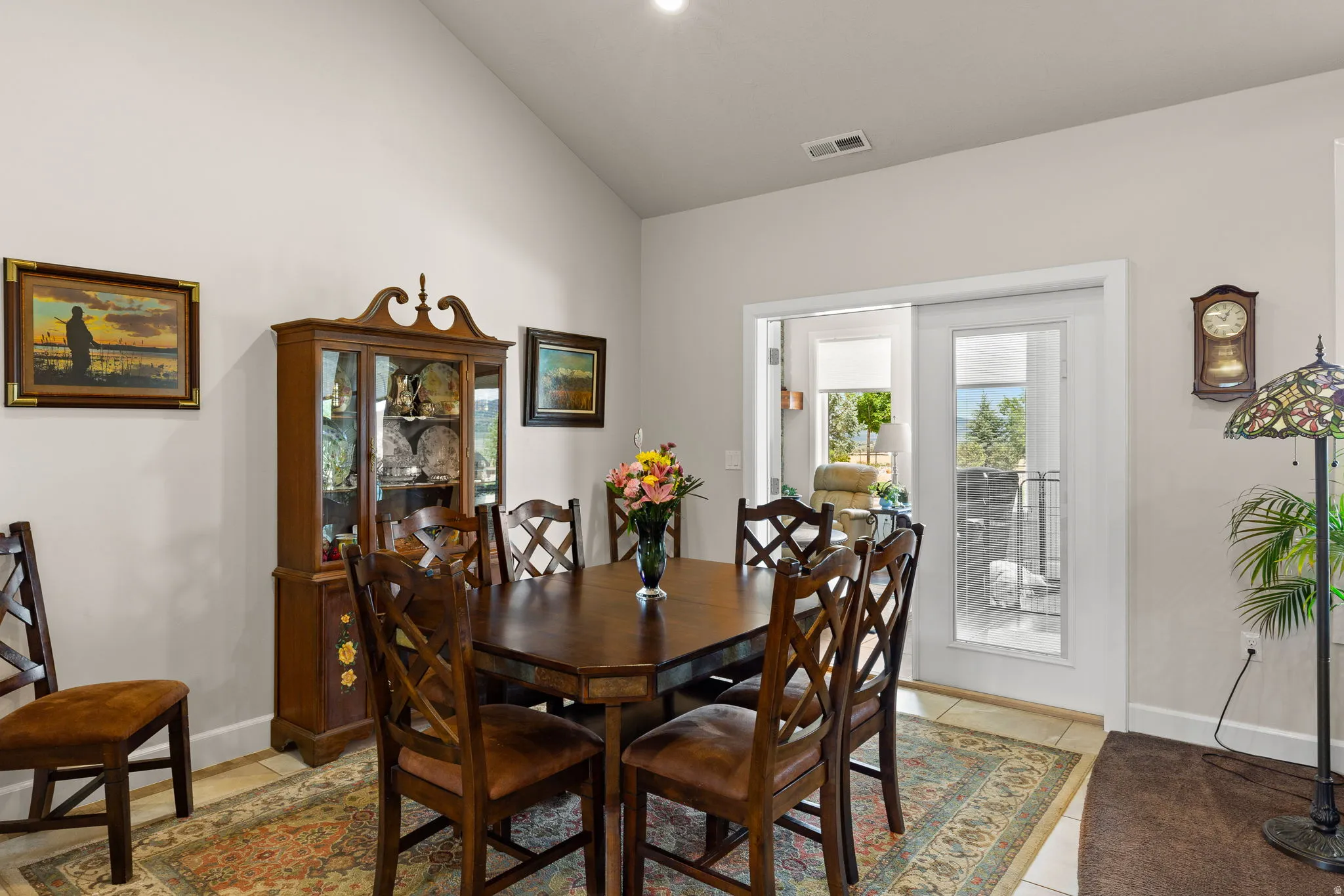 Dining area with vaulted ceiling and baseboards