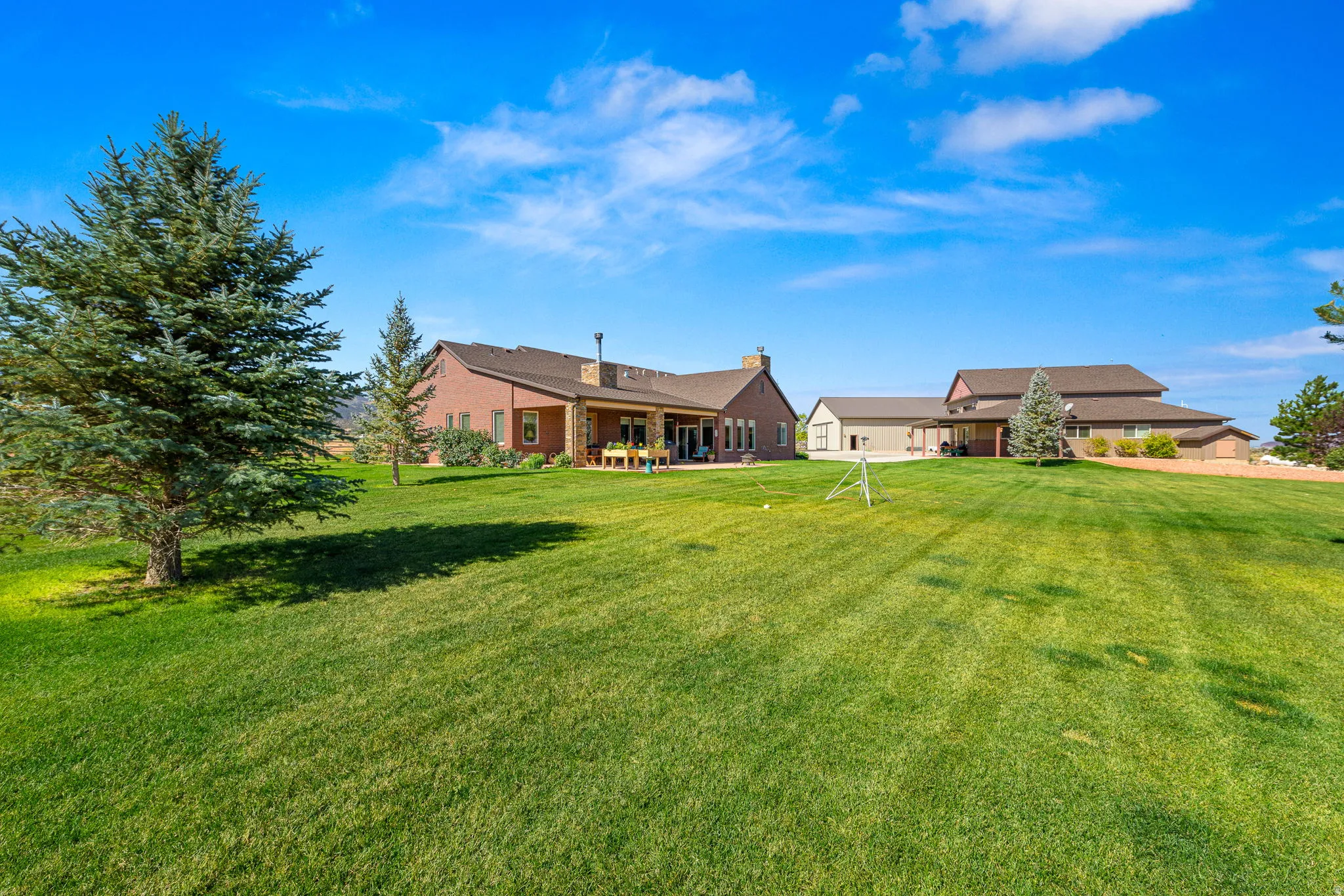Rear view of property with a chimney, a patio area, and a yard