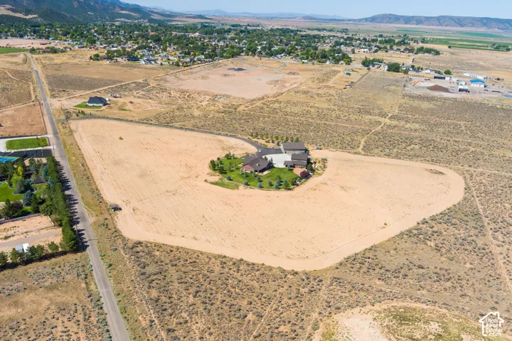 Aerial overview of property's location with rural landscape and a mountain backdrop