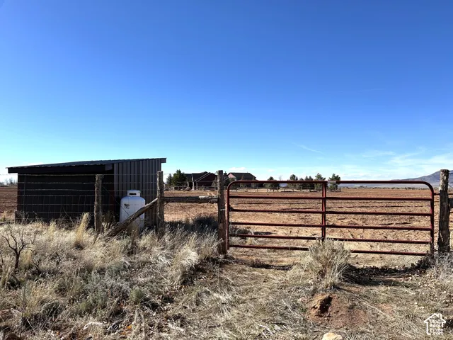 View of yard with a view of rural / pastoral area and a gate
