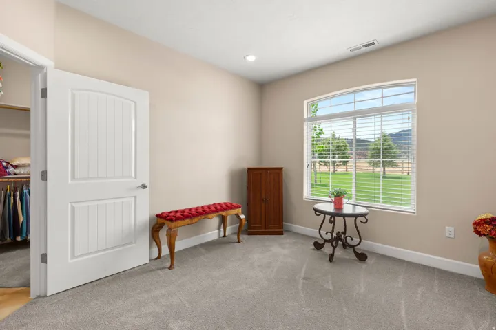 Sitting room with light carpet and recessed lighting