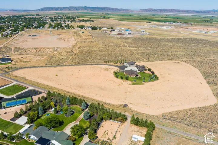 Aerial view of property's location featuring a mountainous background and rural landscape