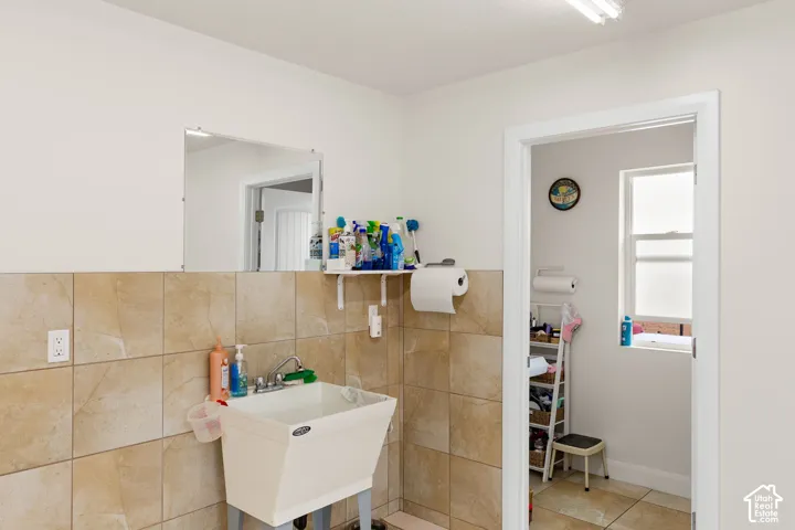 Bathroom with tile walls and a sink
