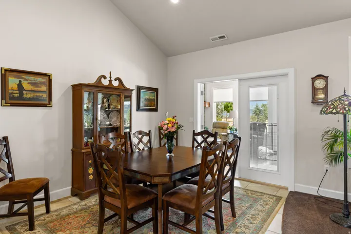 Dining area with vaulted ceiling and baseboards
