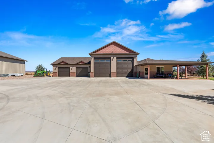 View of front of home featuring driveway and brick siding