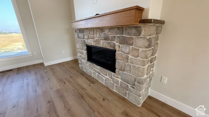 Stone-clad fireplace with a wood mantel