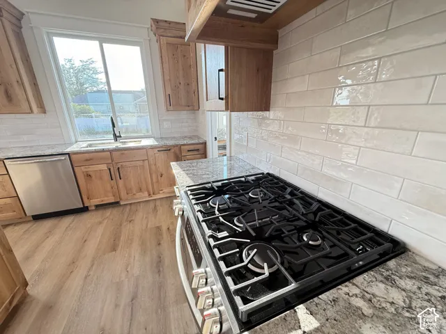 Wood-finish flooring complemented by light wood cabinetry and granite-style countertops