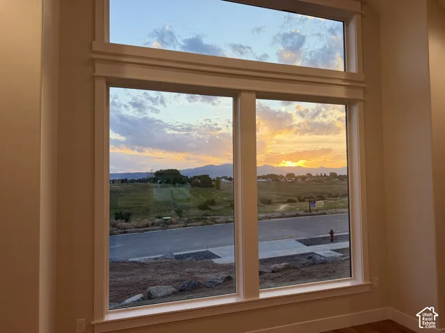 Floor-to-ceiling windows with a transom above frame the exterior scenery