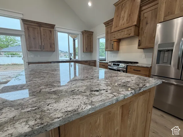Expansive kitchen island featuring a light-toned granite countertop with natural veining
