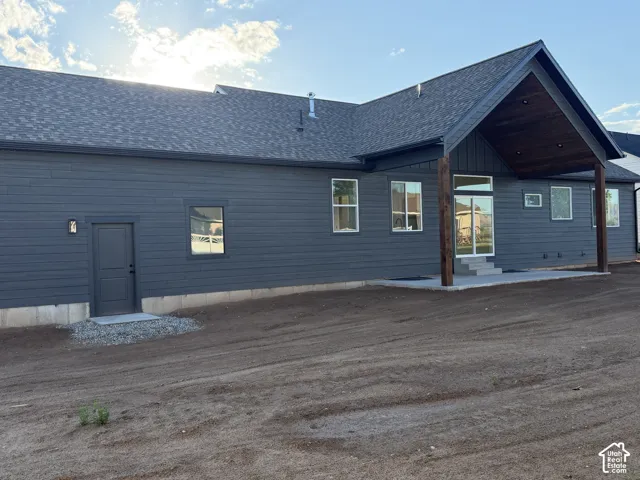 Charcoal siding exterior with a dark shingle roof