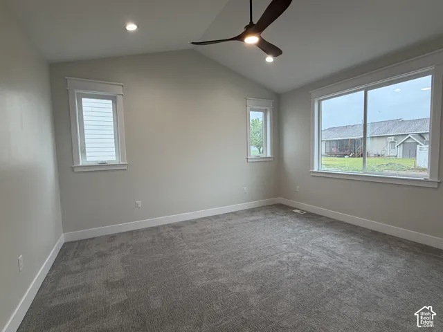 Spacious room featuring vaulted ceilings, recessed lighting, and a contemporary ceiling fan