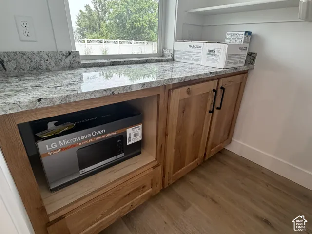 Granite countertops over wood cabinetry with black hardware