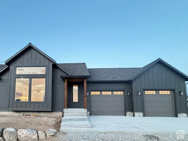 Modern dark-toned exterior featuring vertical board and batten siding and horizontal plank siding