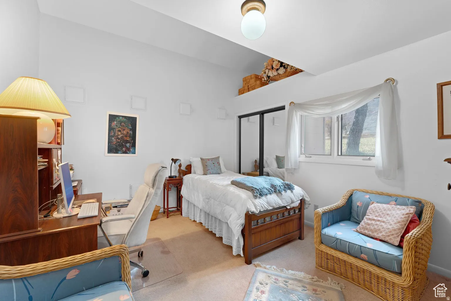 Bedroom featuring carpet flooring, an office area, a closet, and lofted ceiling