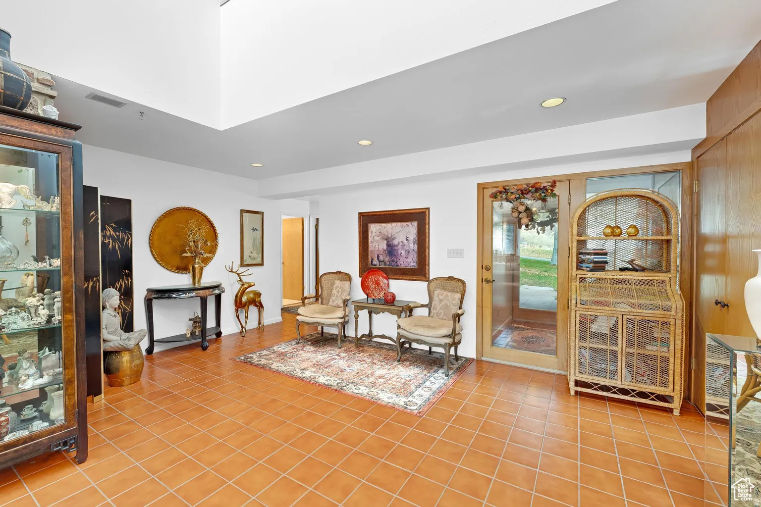Living area with recessed lighting and light tile patterned floors