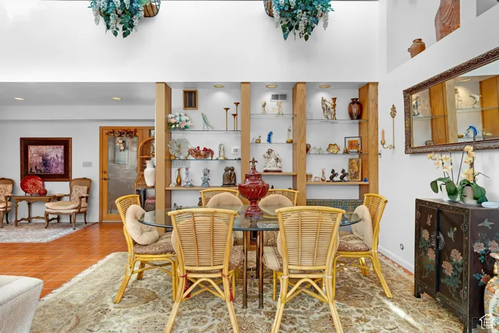 Dining space with light tile patterned floors and recessed lighting