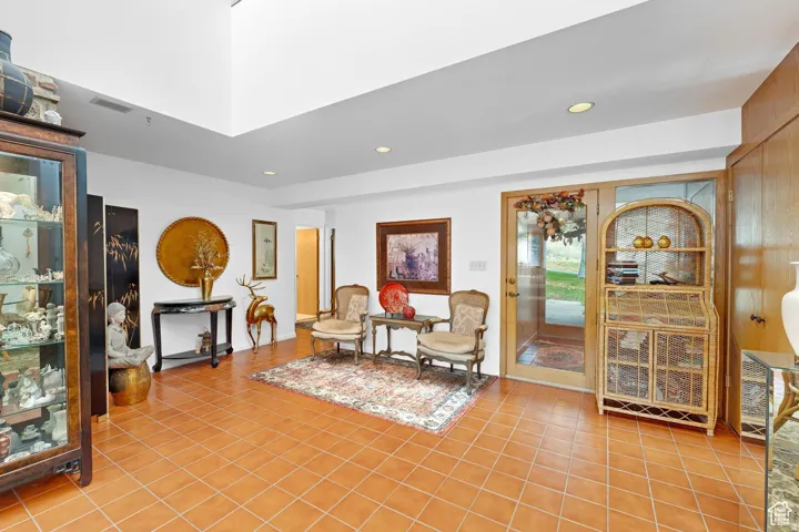 Living area with recessed lighting and light tile patterned floors