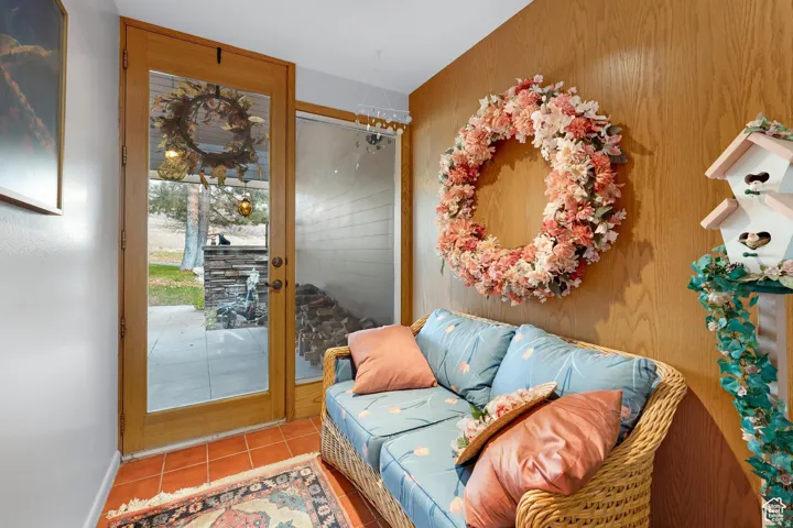 Tiled living room with wood walls