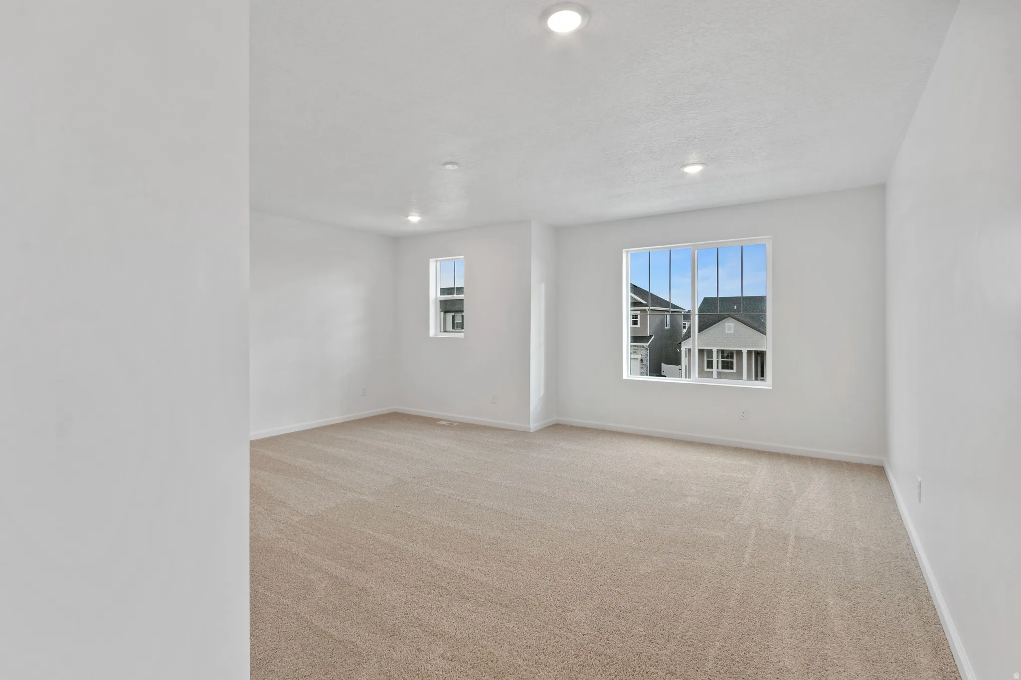 Spare room with light carpet and recessed lighting