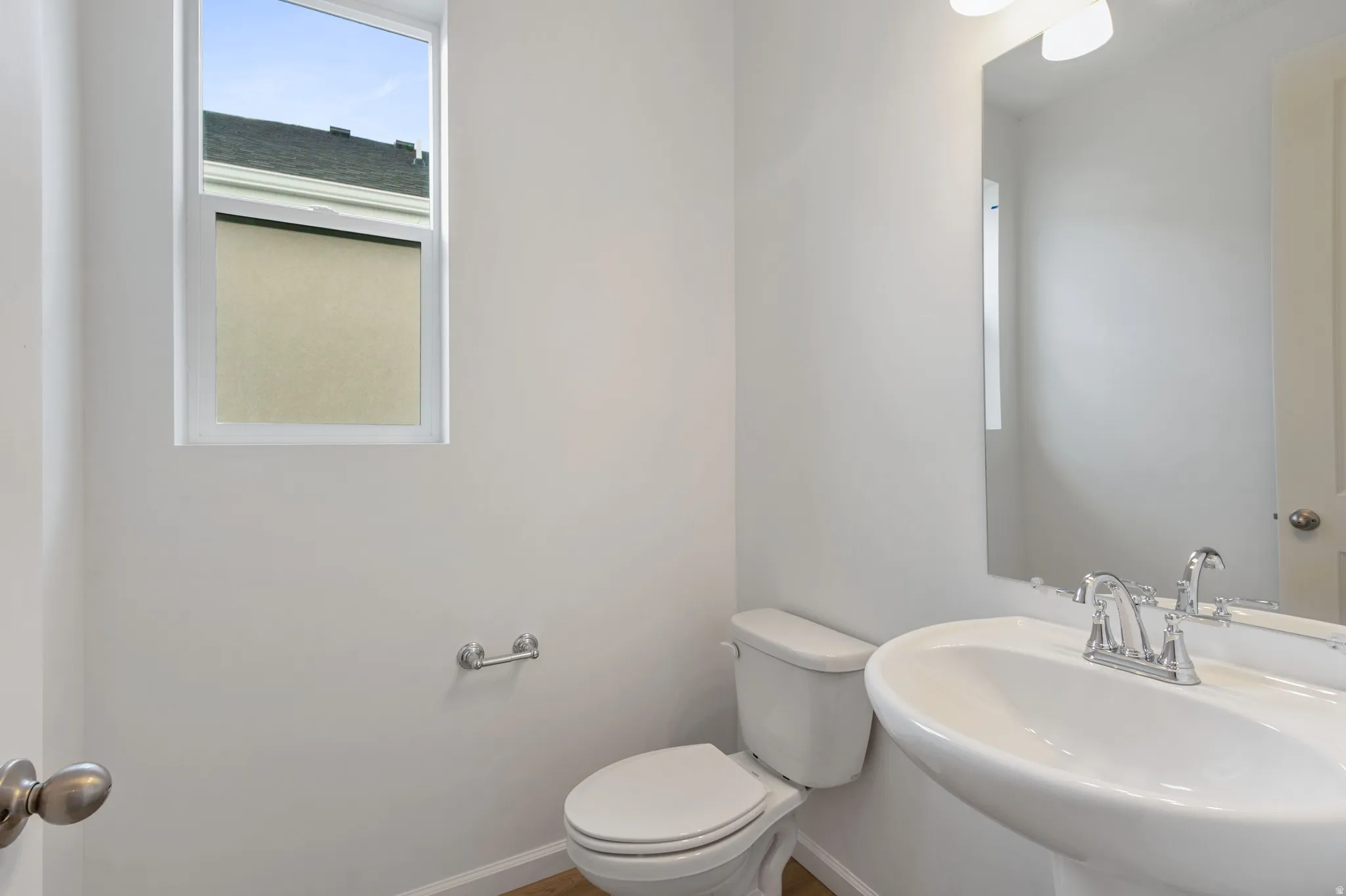 Half bathroom featuring toilet and a sink