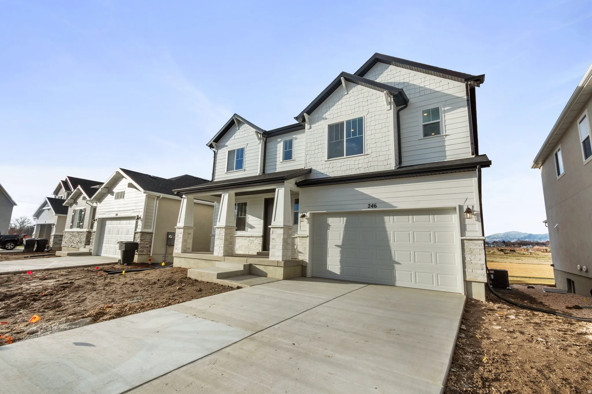 Craftsman-style house with a porch, driveway, and an attached garage
