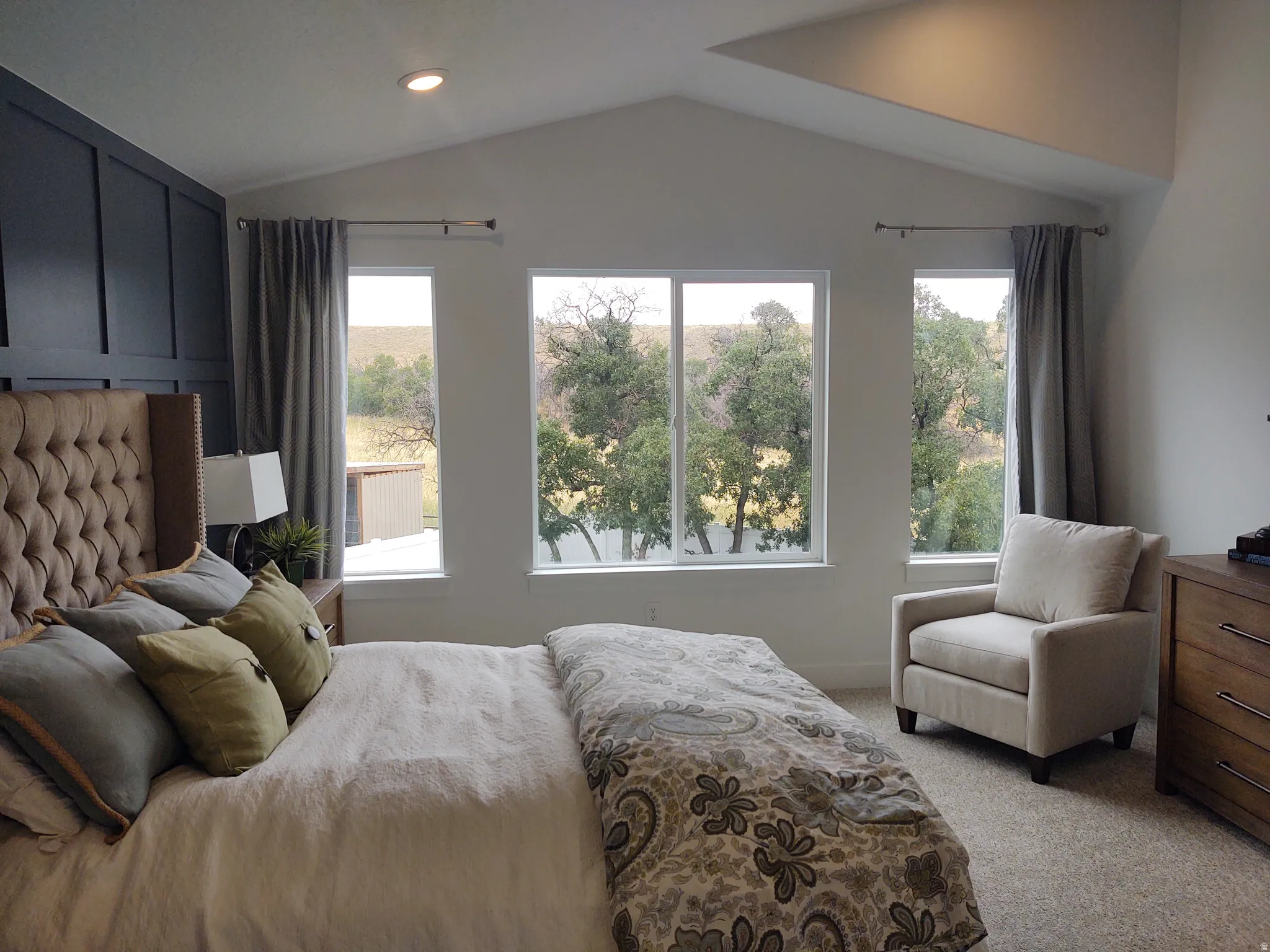 Bedroom with light carpet, vaulted ceiling, and recessed lighting