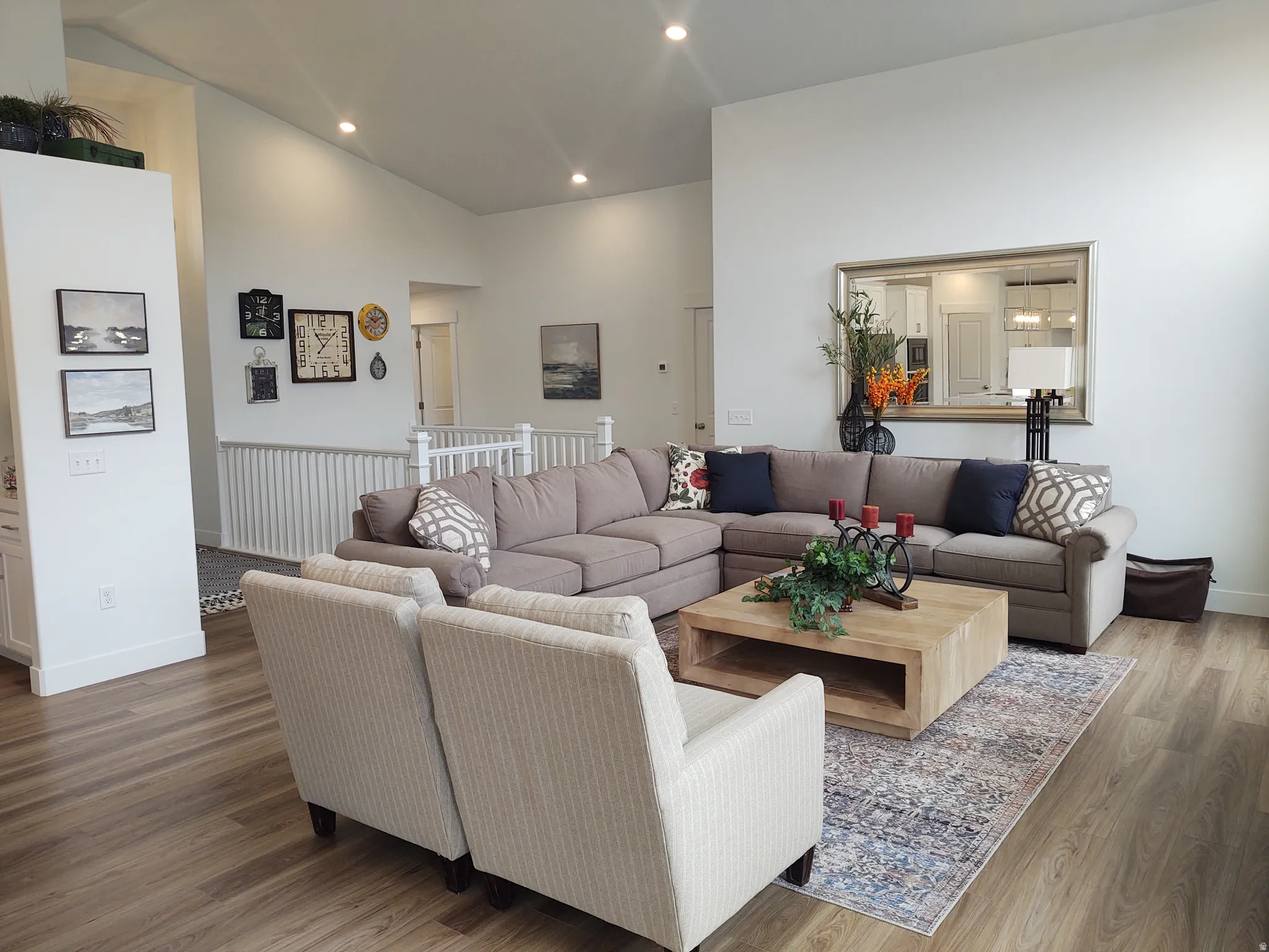 Living room with wood finished floors, lofted ceiling, and recessed lighting