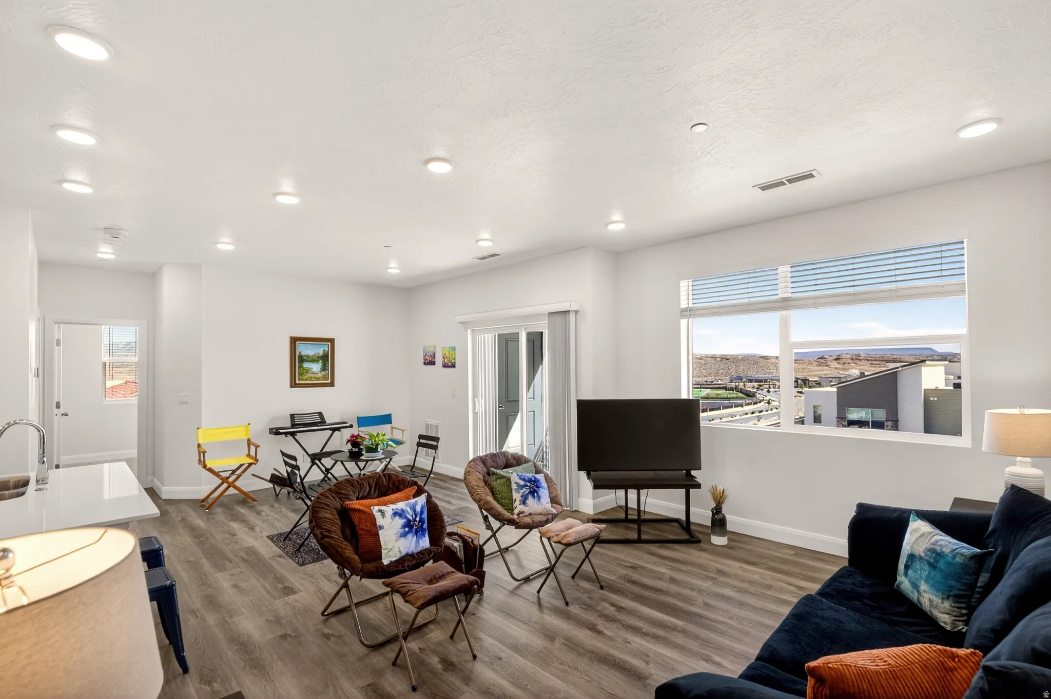 Living area featuring wood finished floors, recessed lighting, and healthy amount of natural light