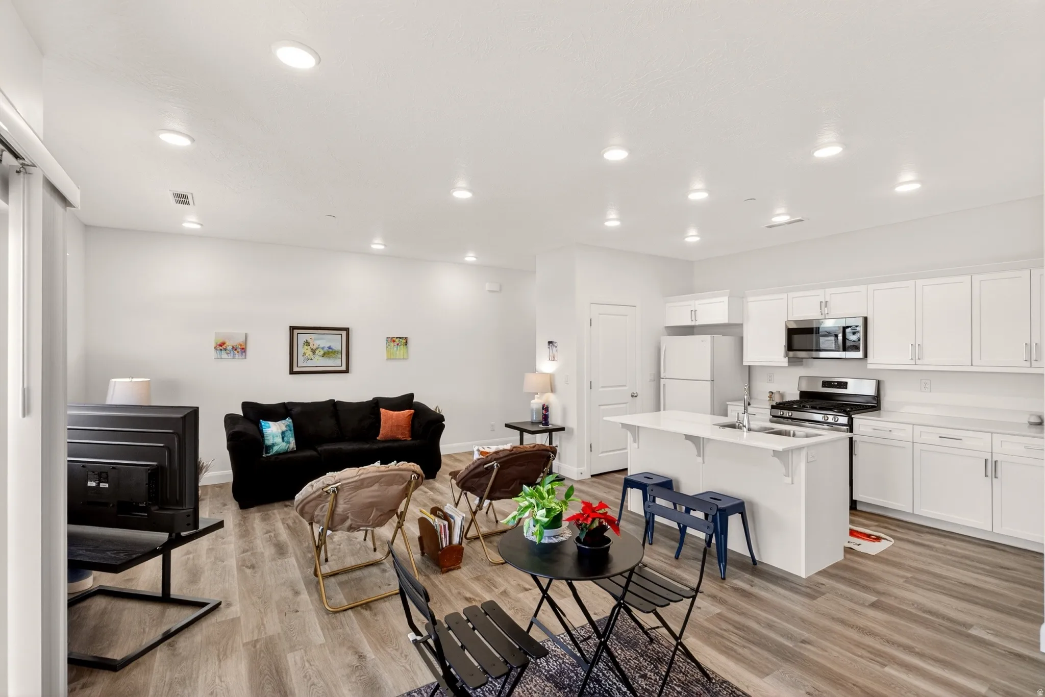 Living area featuring recessed lighting and light wood-style floors